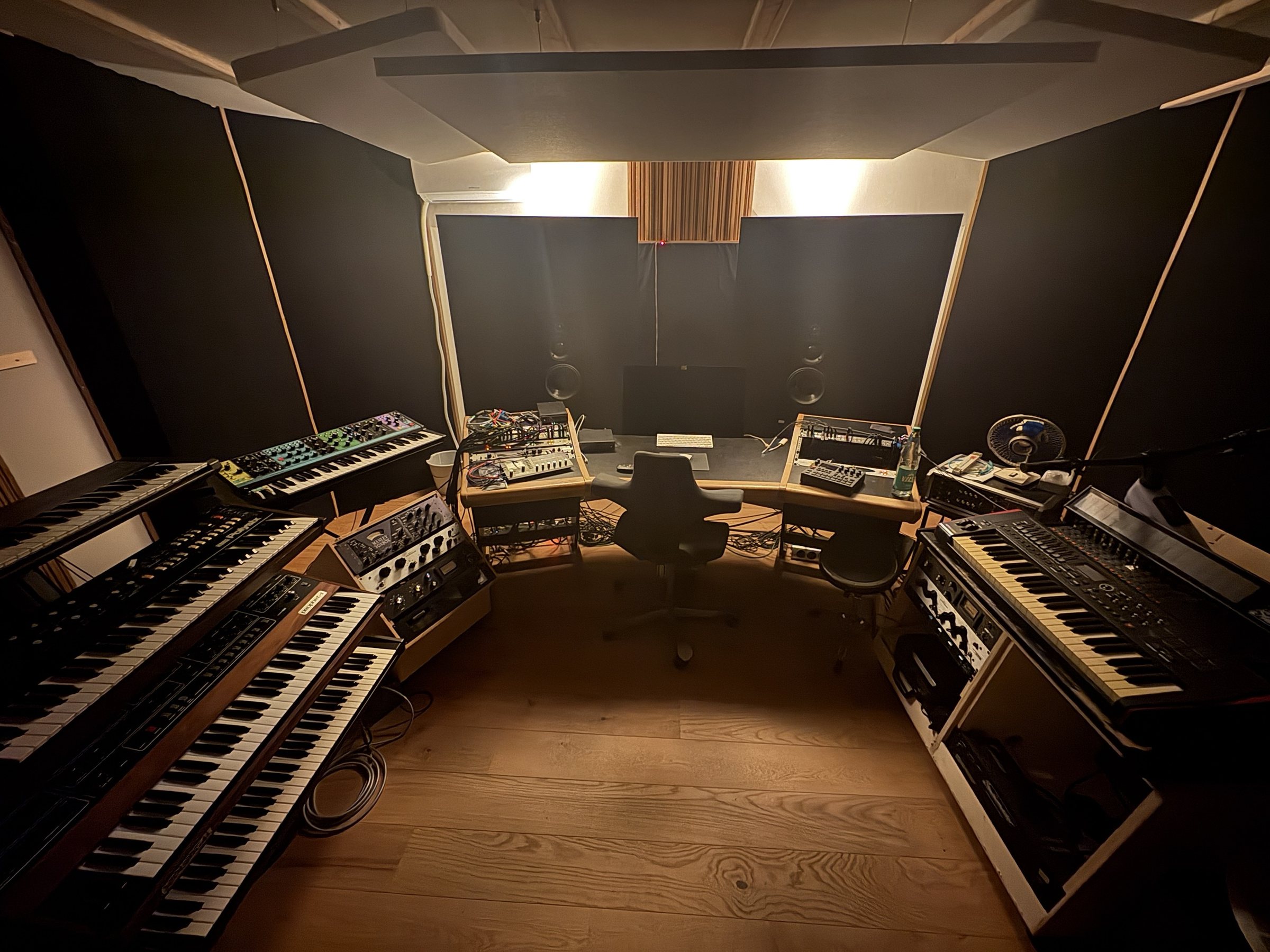 Basti Grub's studio: analog synthesizers and outboard gear around the mixing desk